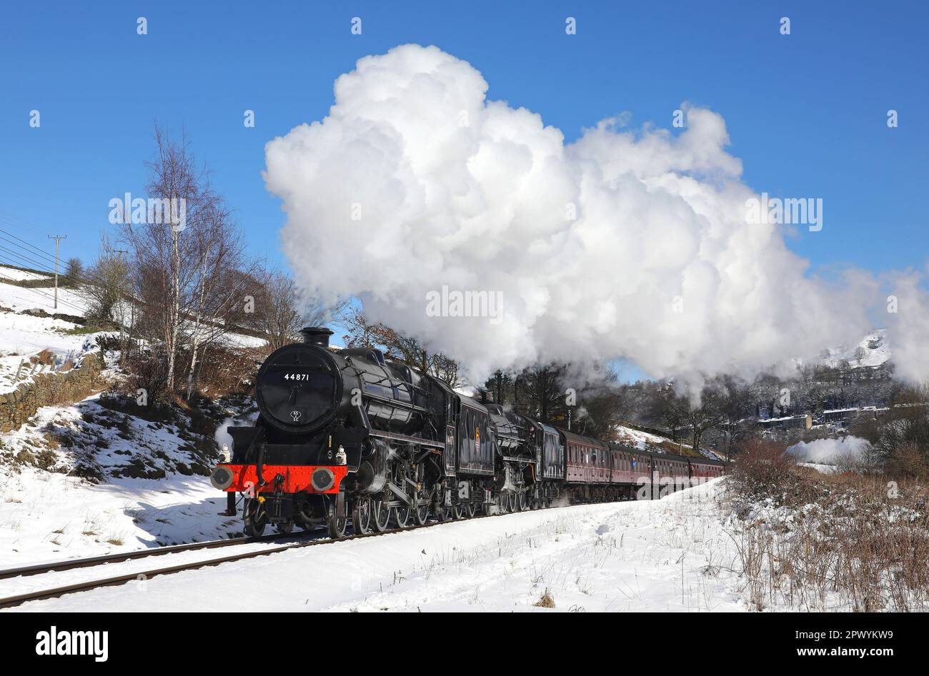 44871 & 45212 approach Oakworth Station on 10.3.23 in beautiful winter conditions. Stock Photo