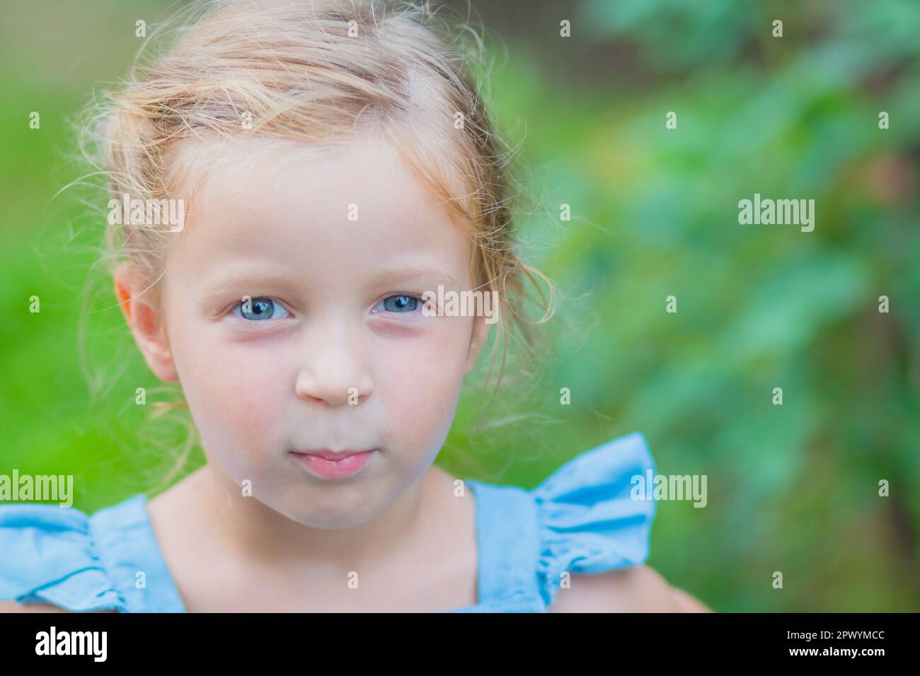 Sweet little girl, two years old. The girl smiles, looks into the