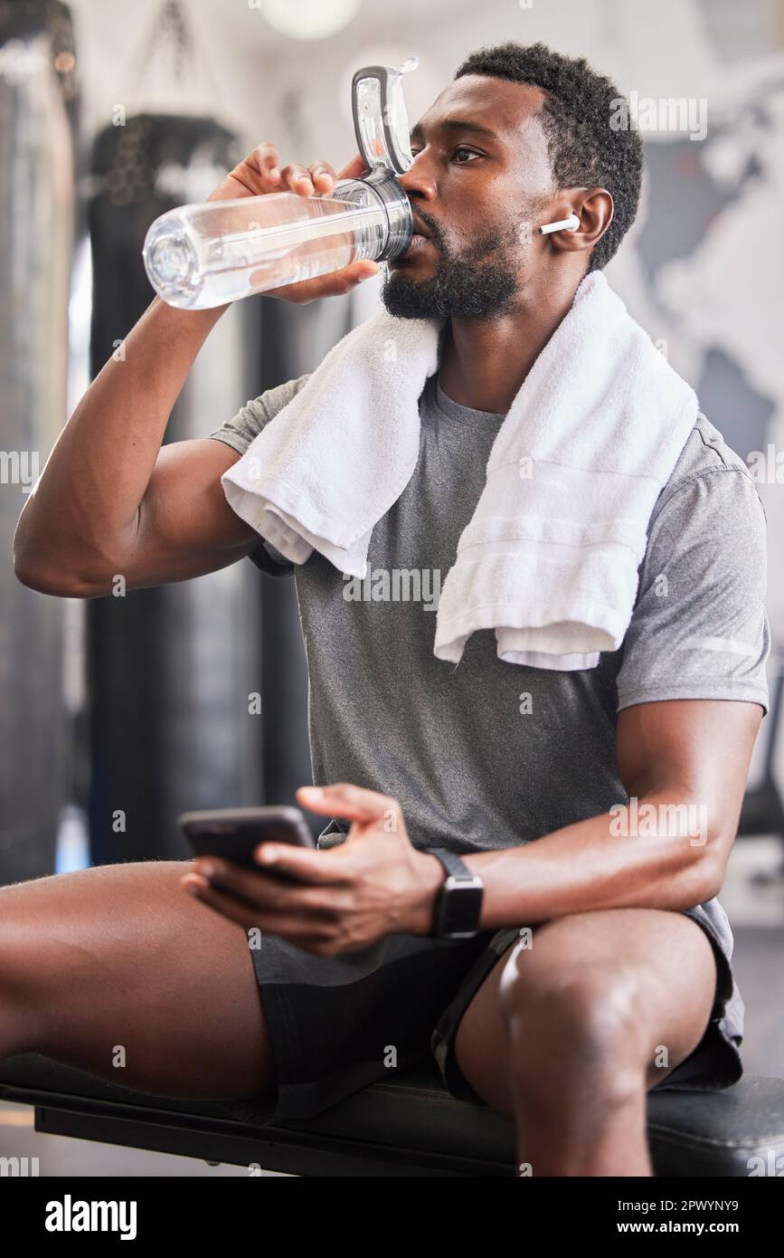 Man with water bottle at gym - Fitness & Wellness News