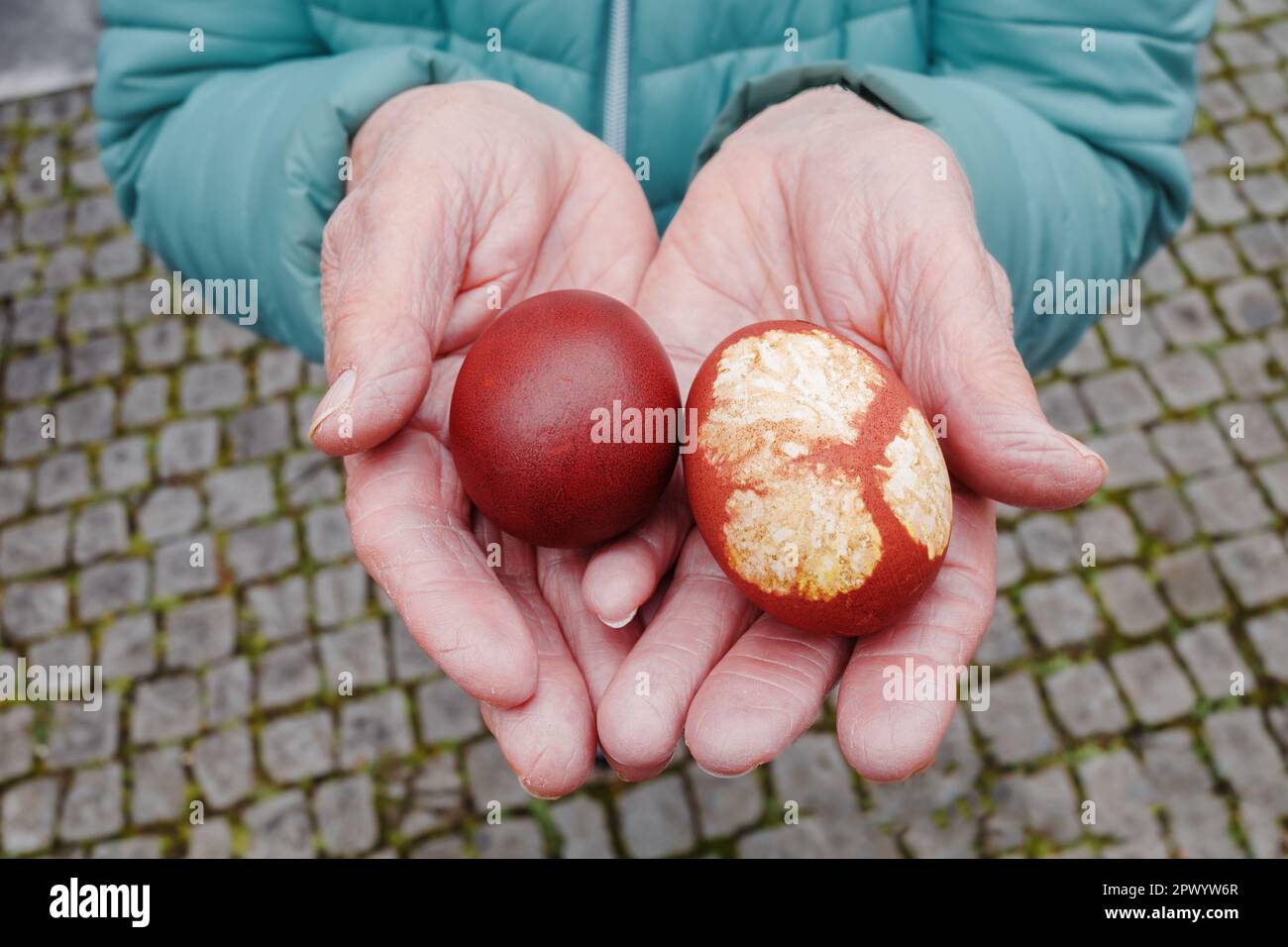 Woman is holding two easter eggs in her hands Stock Photo