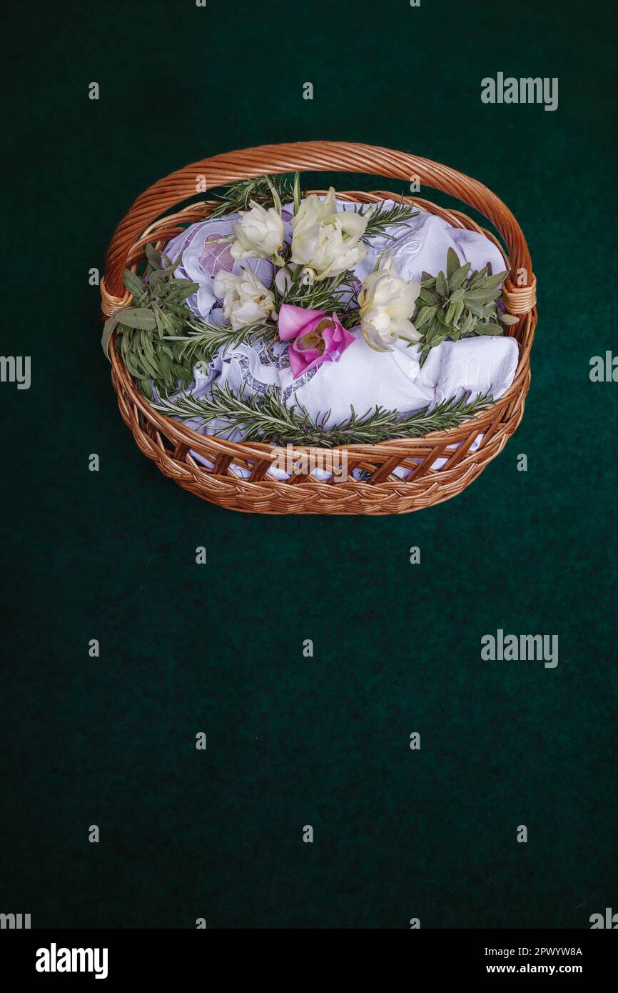 Easter basket on turquoise background, decorated with flowers and