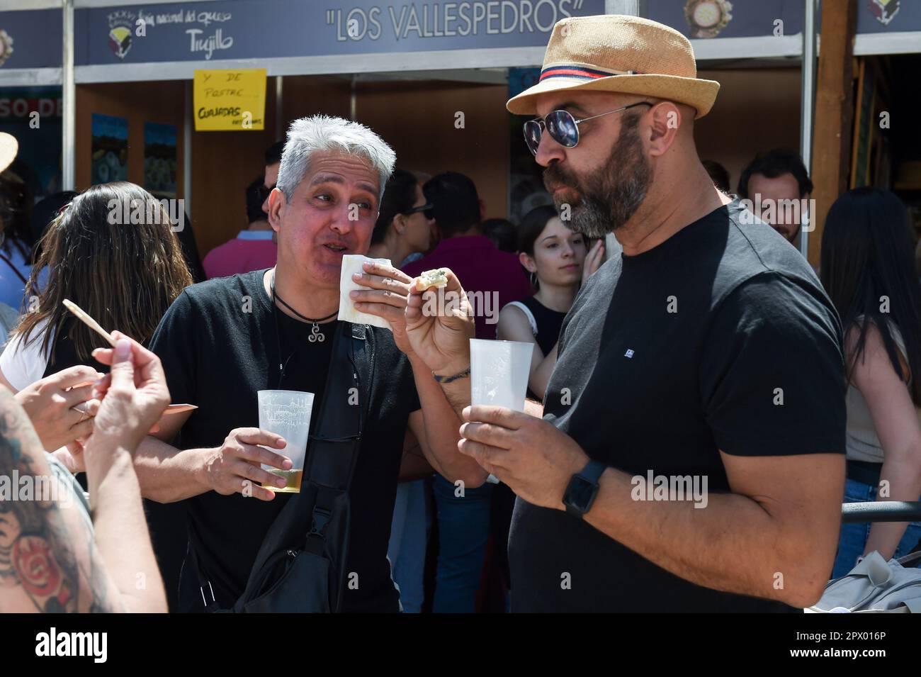 Two men taste cheese during the XXXVI Trujillo National Cheese Fair at the Plaza Mayor, on May 1