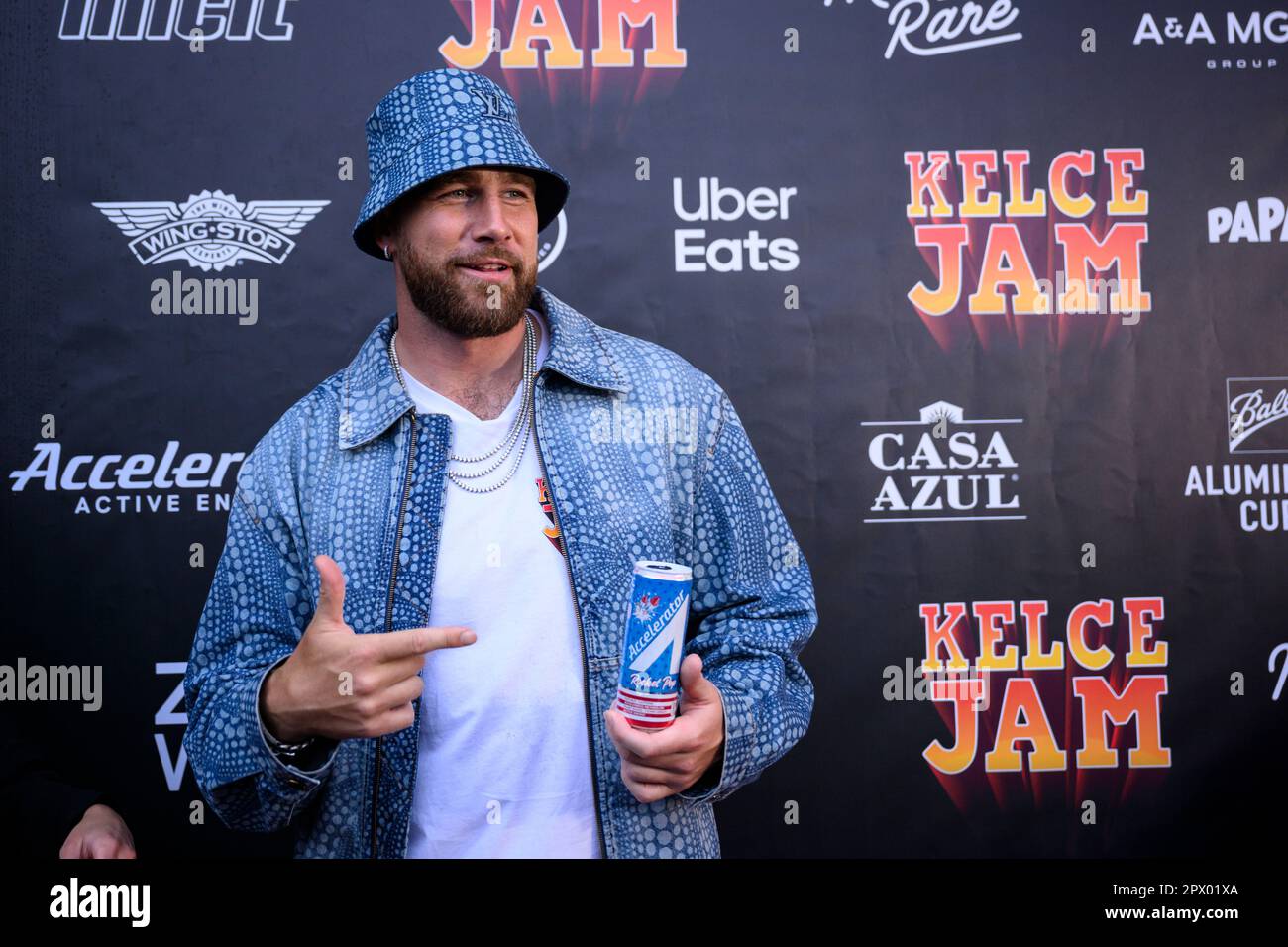 Travis Kelce, Kansas City Chiefs tight end and host of Kelce Jam, poses on the red carpet at the