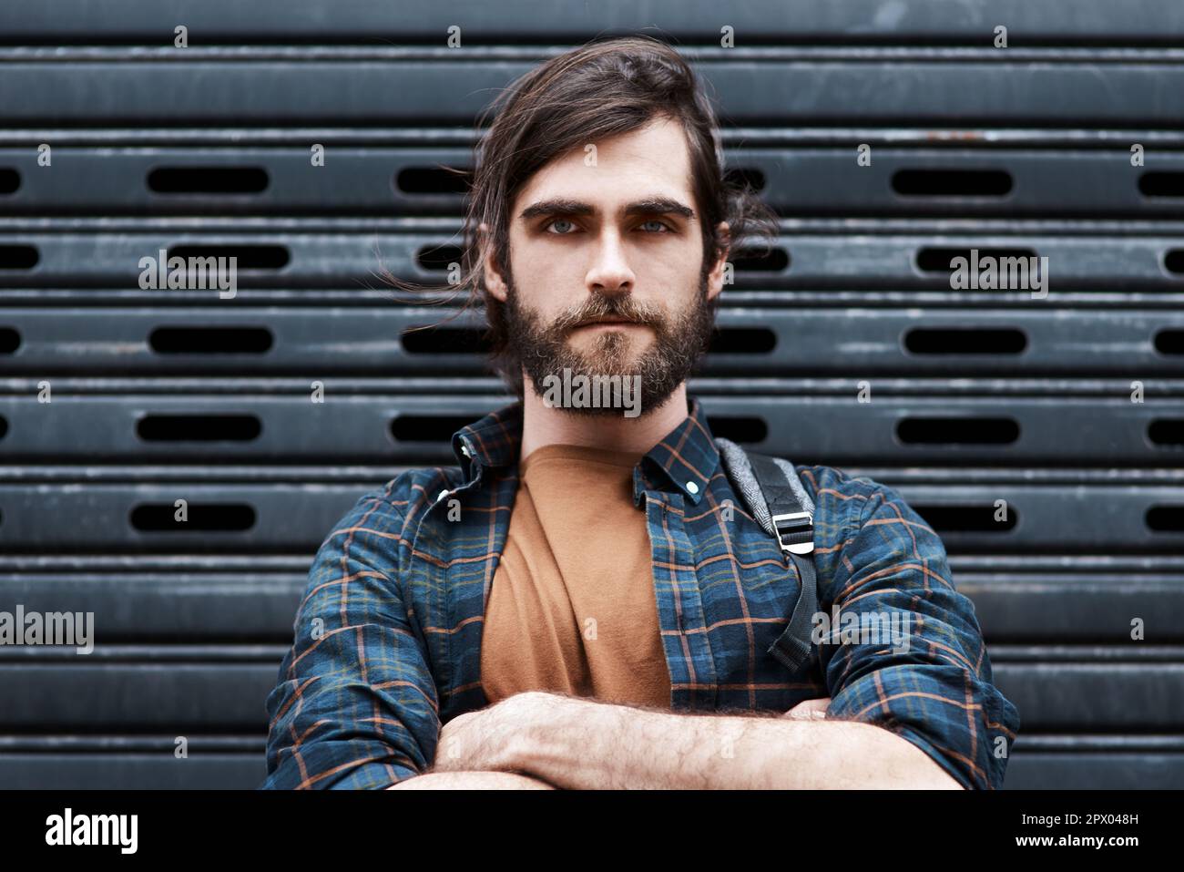 Were not playing any games on this side. Portrait of a handsome young man posing with his arms