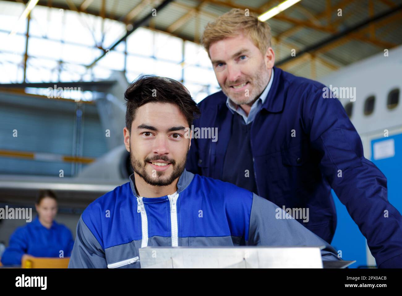 workers of airliner factory posing and smiling Stock Photo
