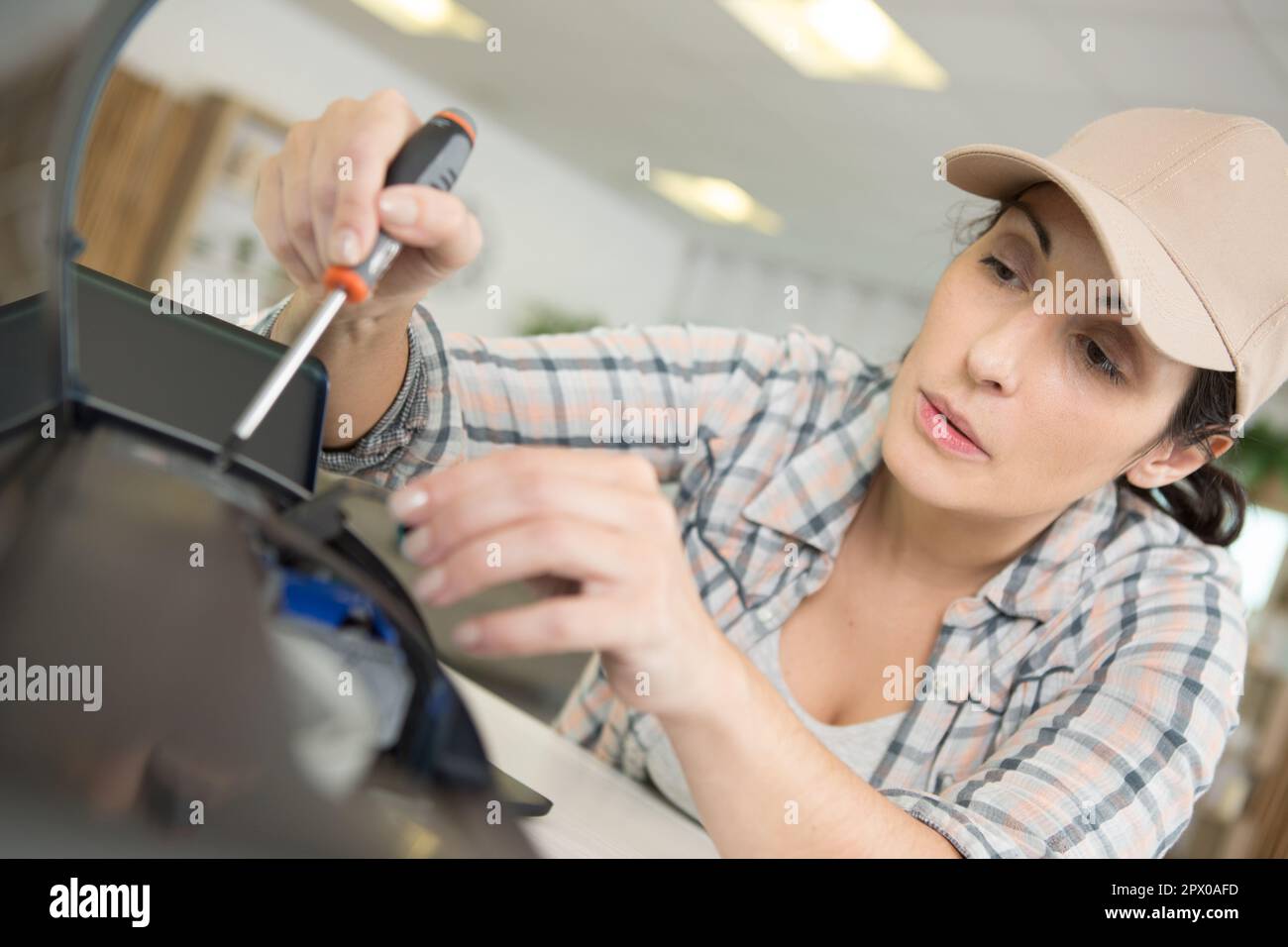 a female technician fixing printer Stock Photo