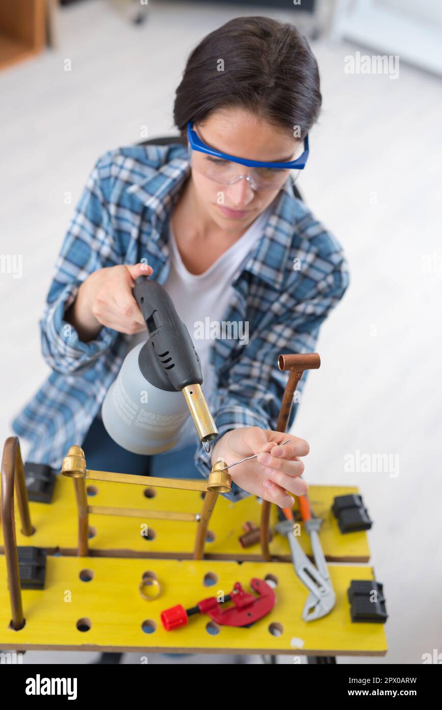 female industrial plumber using blowtorch Stock Photo Alamy