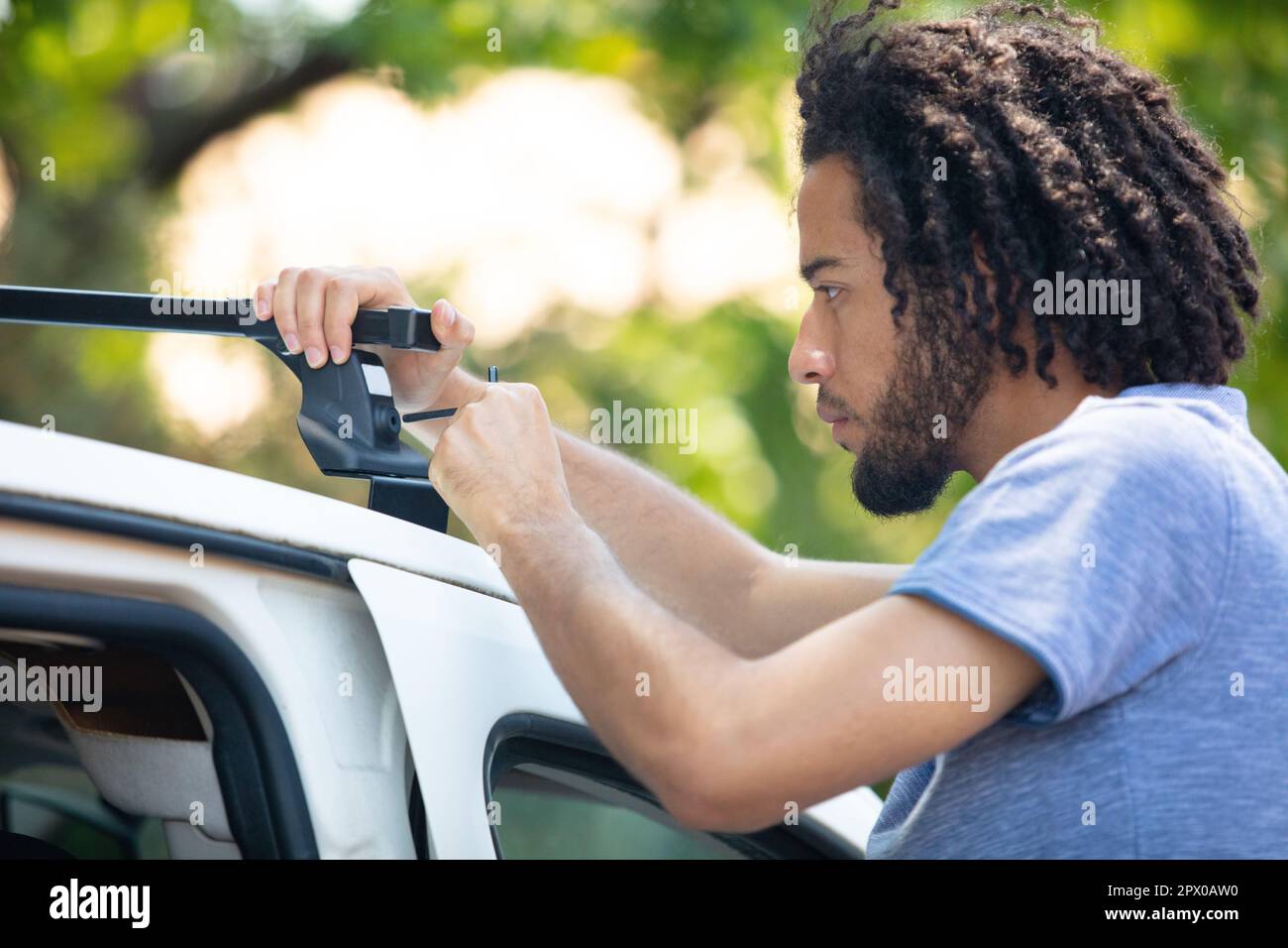 man installing a car roof rack on his car Stock Photo Alamy