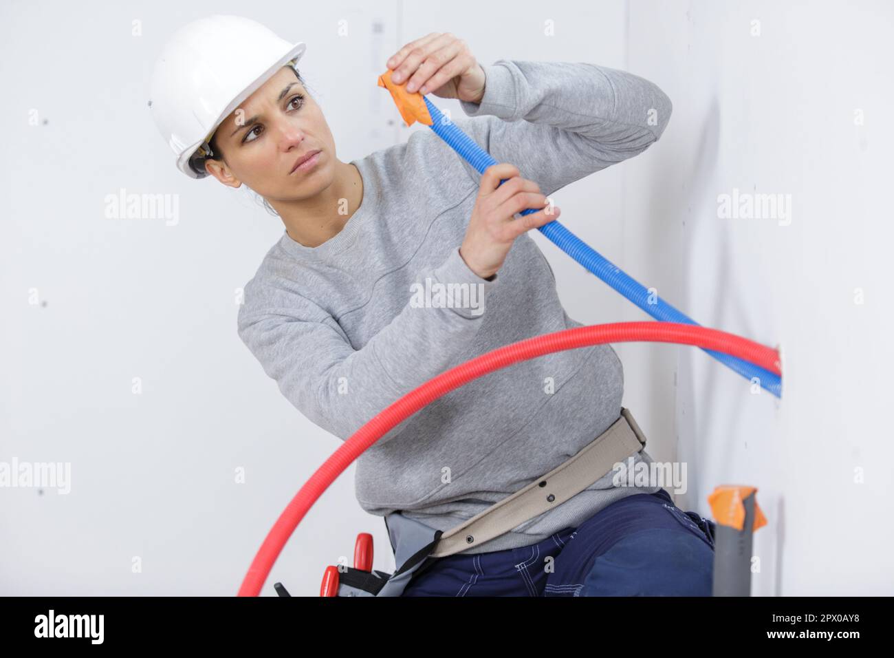 female electrician on construction site Stock Photo