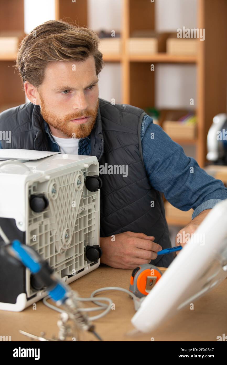 handyman is testing an air conditioning Stock Photo Alamy