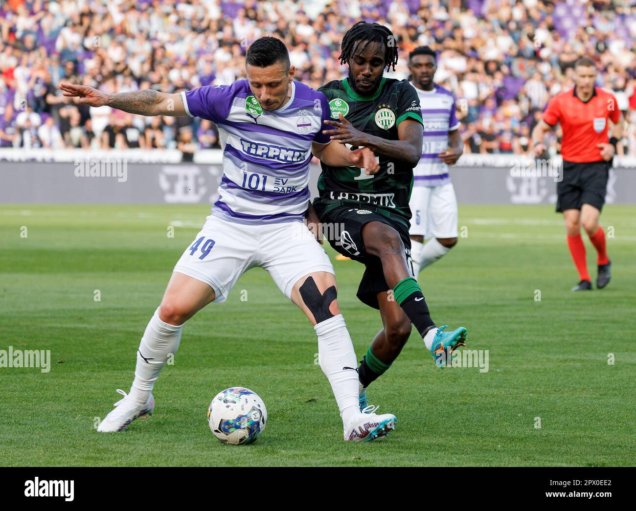 Petrus Boumal of Ujpest FC competes for the ball with Jose Marcos