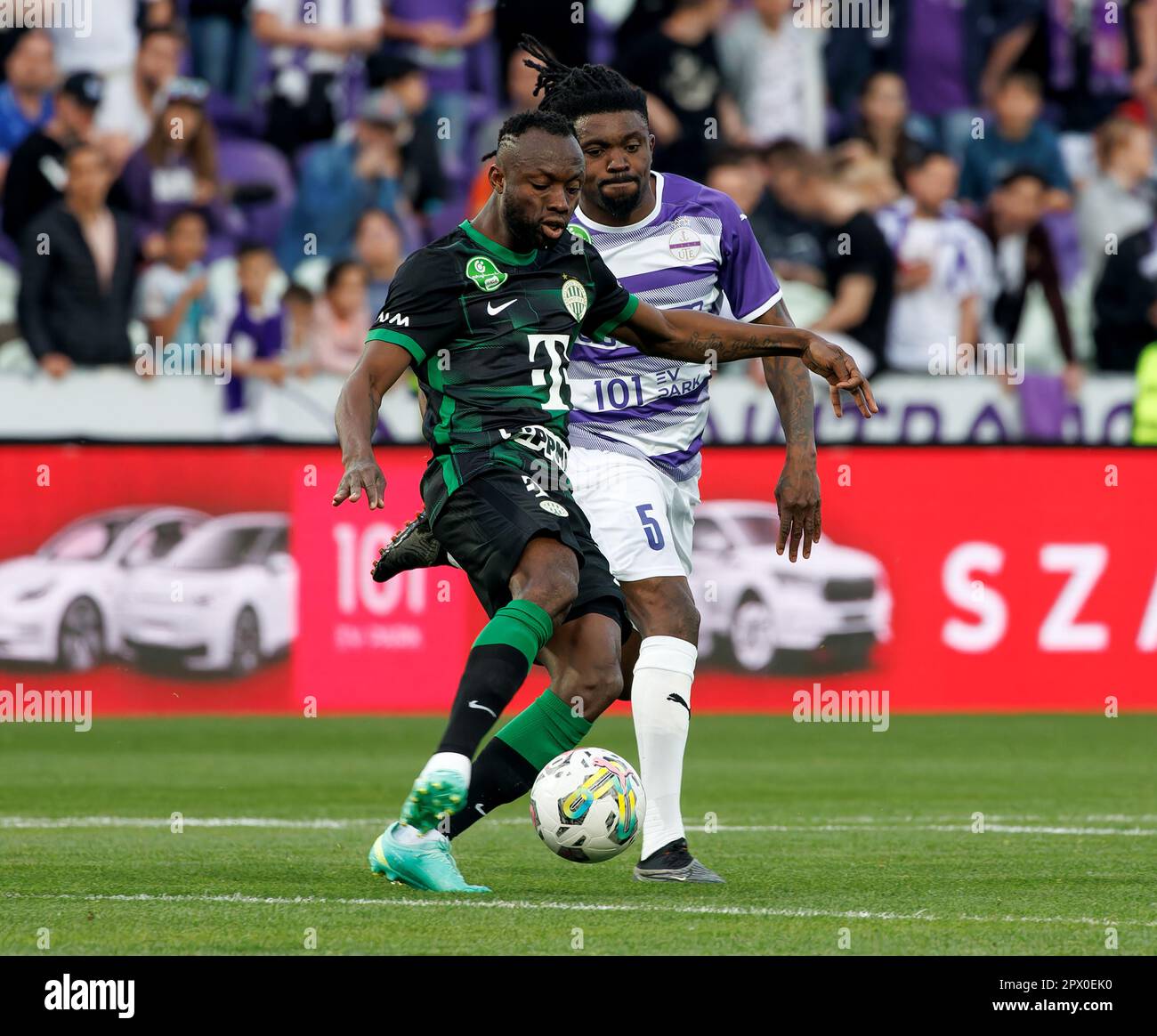 Anderson Esiti of Ferencvarosi TC challenges Luis Jakobi of Ujpest