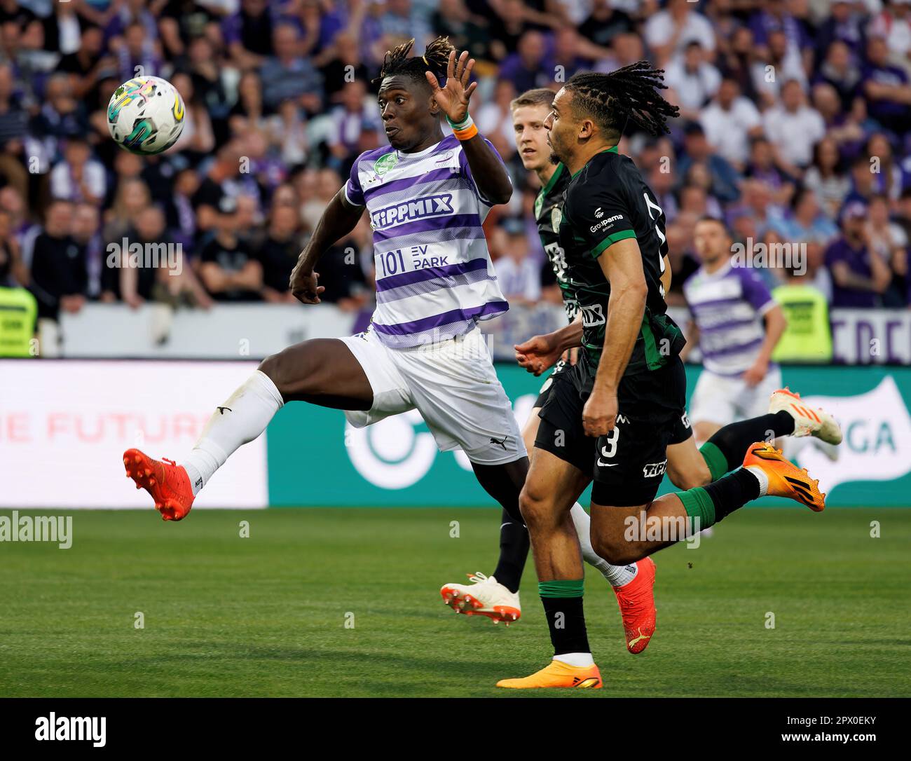 Anderson Esiti of Ferencvarosi TC challenges Luis Jakobi of Ujpest