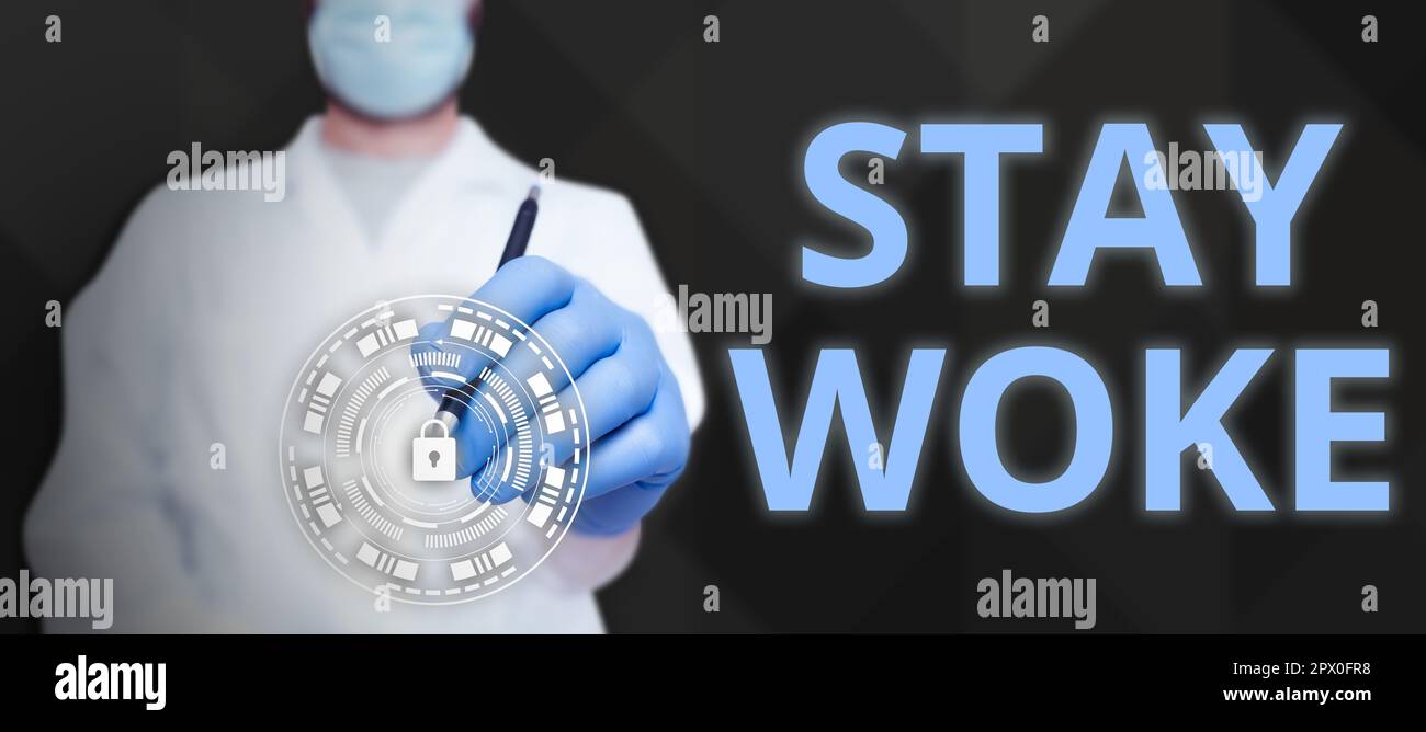 Sign displaying Stay Woke. Concept meaning being aware of your surroundings  and things going on Keep informed Stock Photo - Alamy
