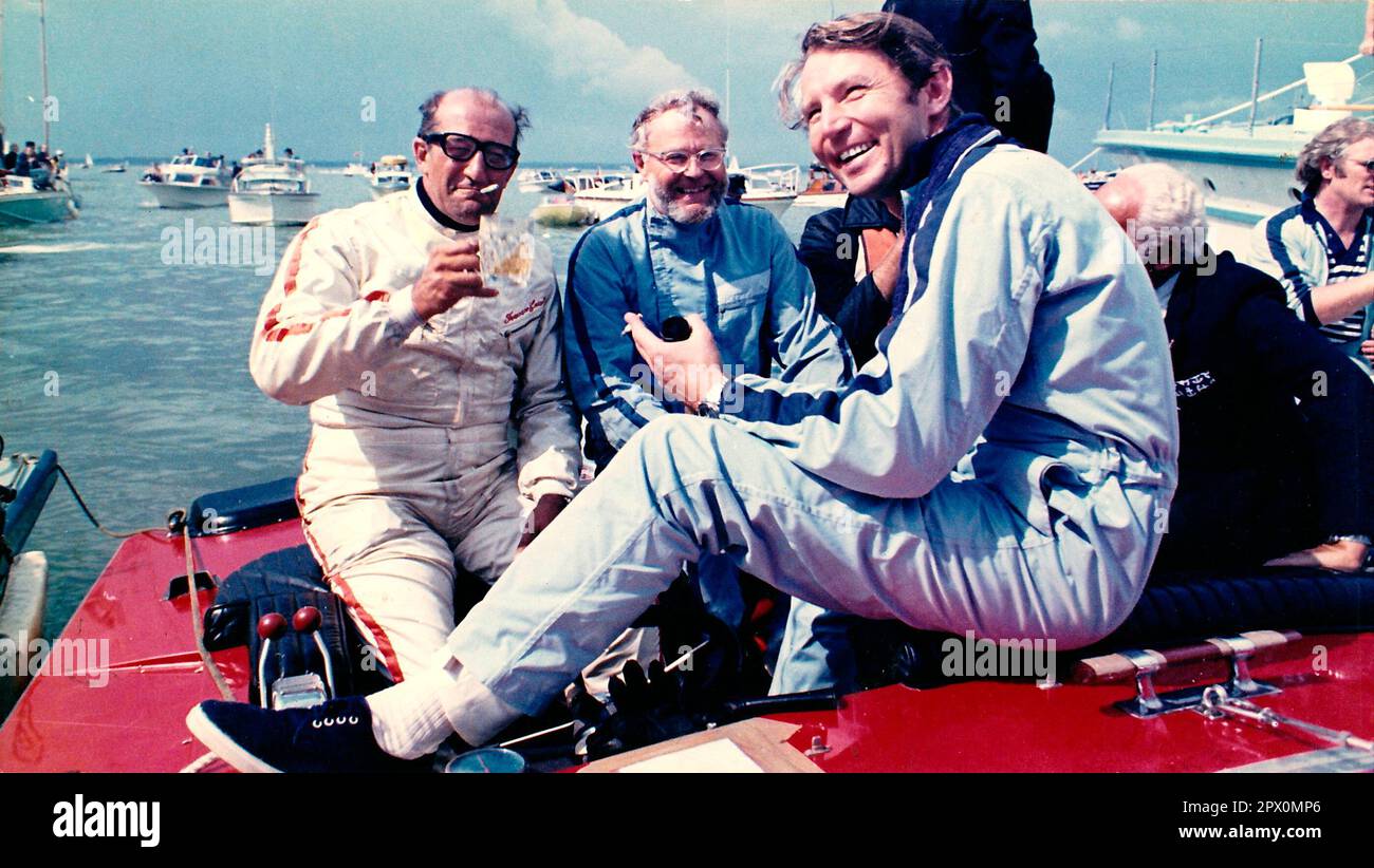 AJAXNETPHOTO. 23RD AUGUST, 1970. COWES, ENGLAND. - COWES - TORQUAY -COWES POWERBOAT RACE - (L-R, FROM BACK). FRANCESCO COSENTINO (IT), LADY NARA DRIVER, CHARLES GARDNER OF SURFURY III (GBR) AND TOMMY SOPWITH (FRONT) WHO DROVE MISS ENFIELD II TO VICTORY, CELEBRATE ON BOARD LADY NARA WHILE MOORED ALONGSIDE SOUTHERNER T.V. BOAT IN THE HARBOUR.PHOTO:JONATHAN EASTLAND/AJAX  C357020 REF:222904 1 Stock Photo