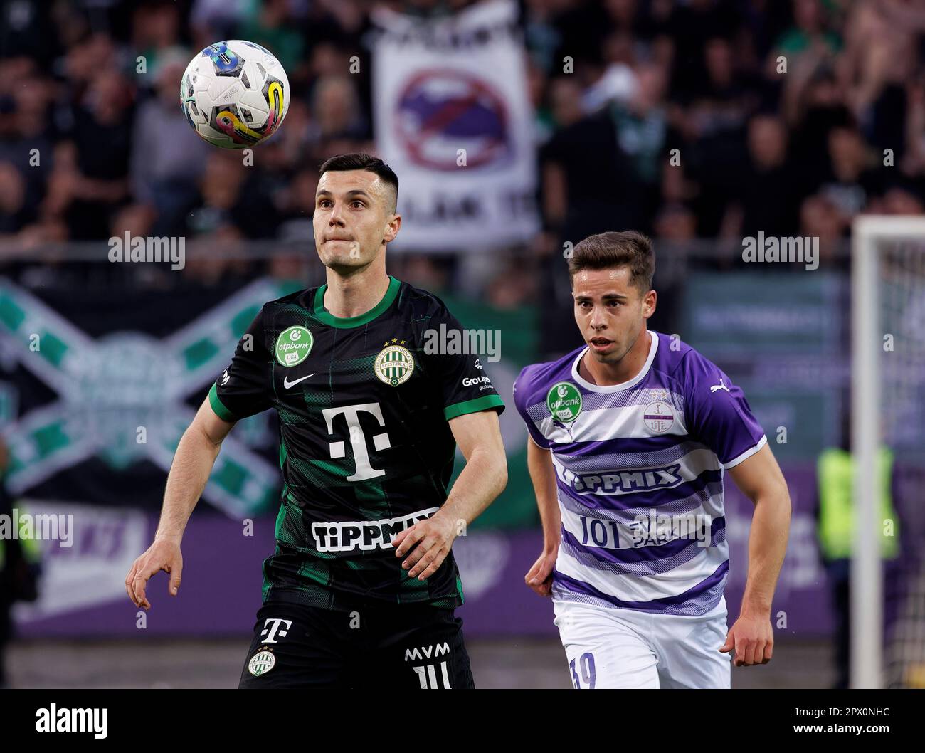 Anderson Esiti of Ferencvarosi TC challenges Luis Jakobi of Ujpest