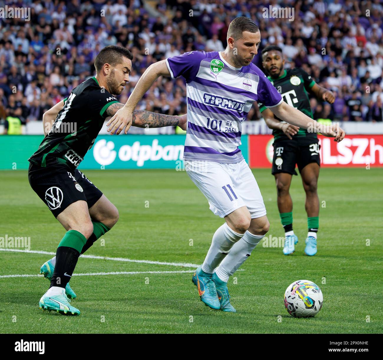 Petrus Boumal of Ujpest FC competes for the ball with Jose Marcos