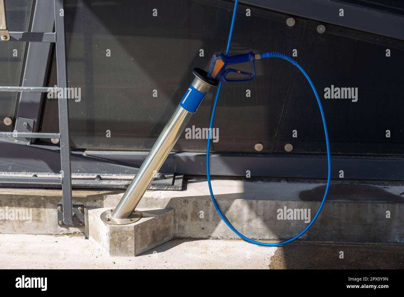 A highpressure washing gun in a holder at a selfservice car wash