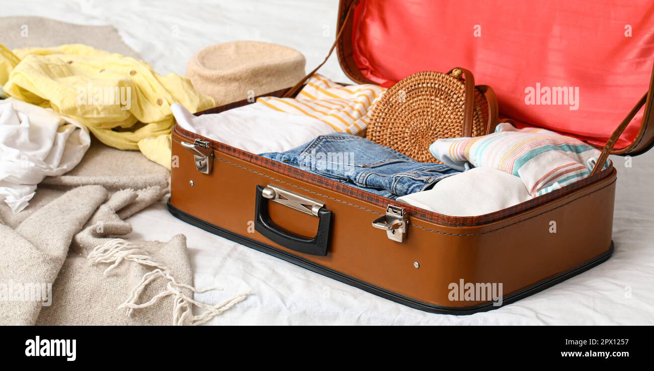 Open packed suitcase on bed Stock Photo Alamy
