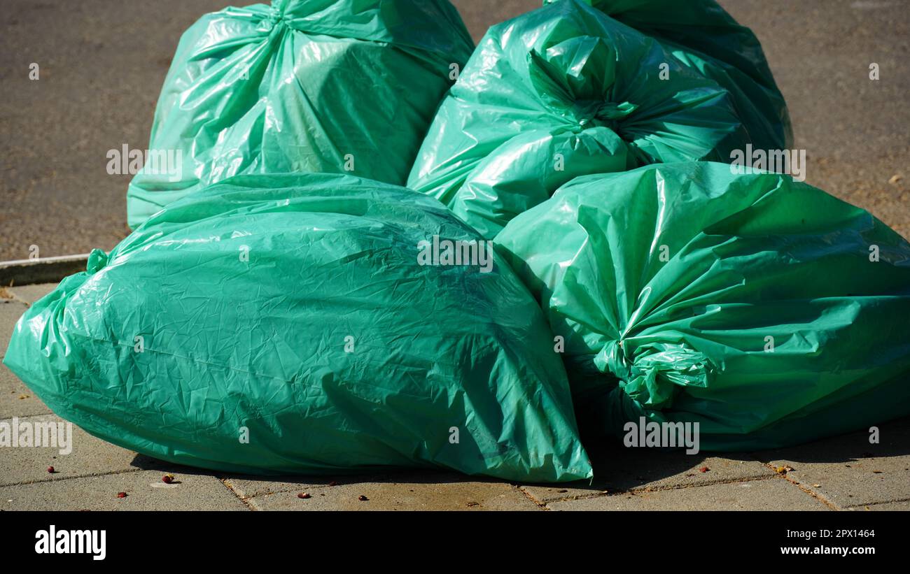 The waste, green full trash bags or garbage bags before take out ...