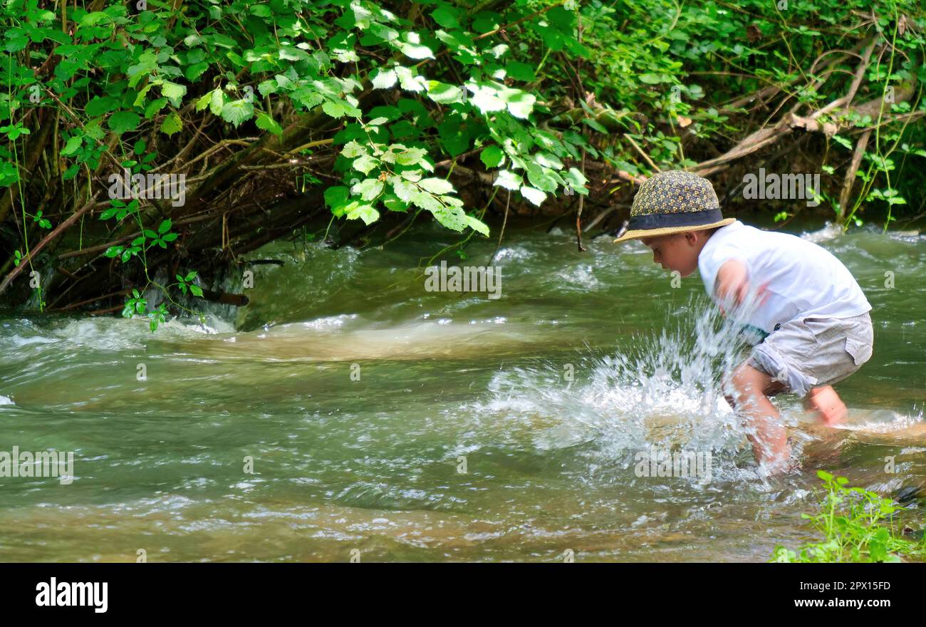 young boy playing in the river Stock Photo - Alamy