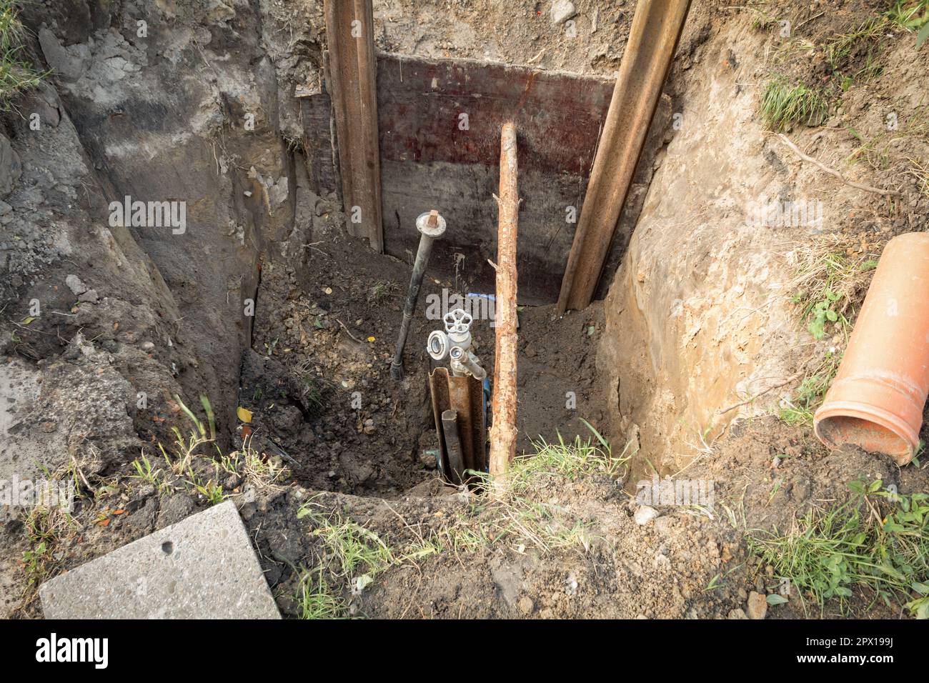 A hole was dug to repair the pipe and change the tap. Sewer trench with