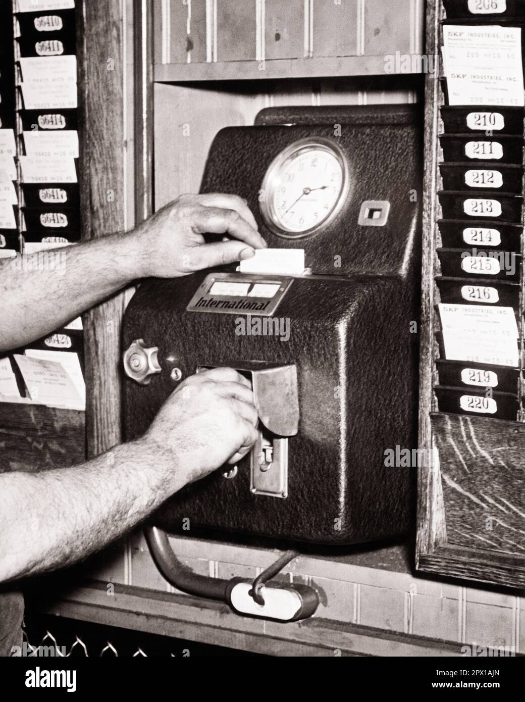 1940s dirty hands of industrial workman punching out after his shift on