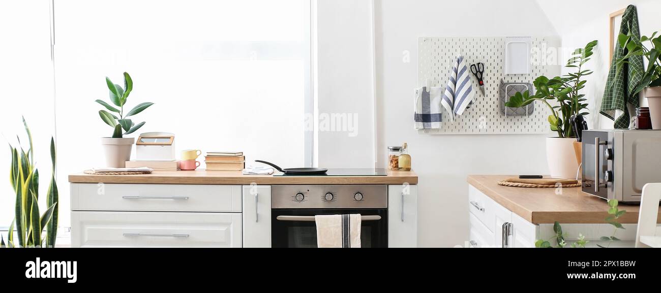 Light kitchen interior with modern furniture and pegboard Stock Photo ...