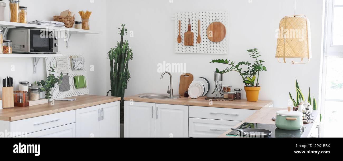 Light kitchen interior with modern furniture and pegboards Stock Photo ...