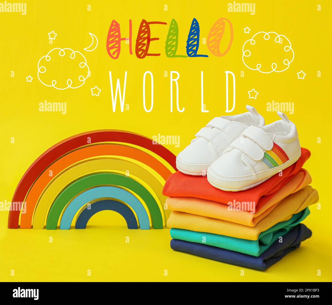 Banner with text HELLO WORLD, baby clothes and rainbow Stock Photo - Alamy