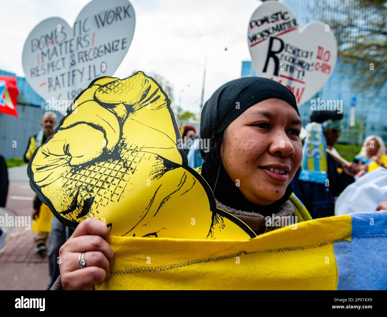 Amsterdam, Netherlands. 01st May, 2023. A domestic worker is seen holding a big plastic fist as