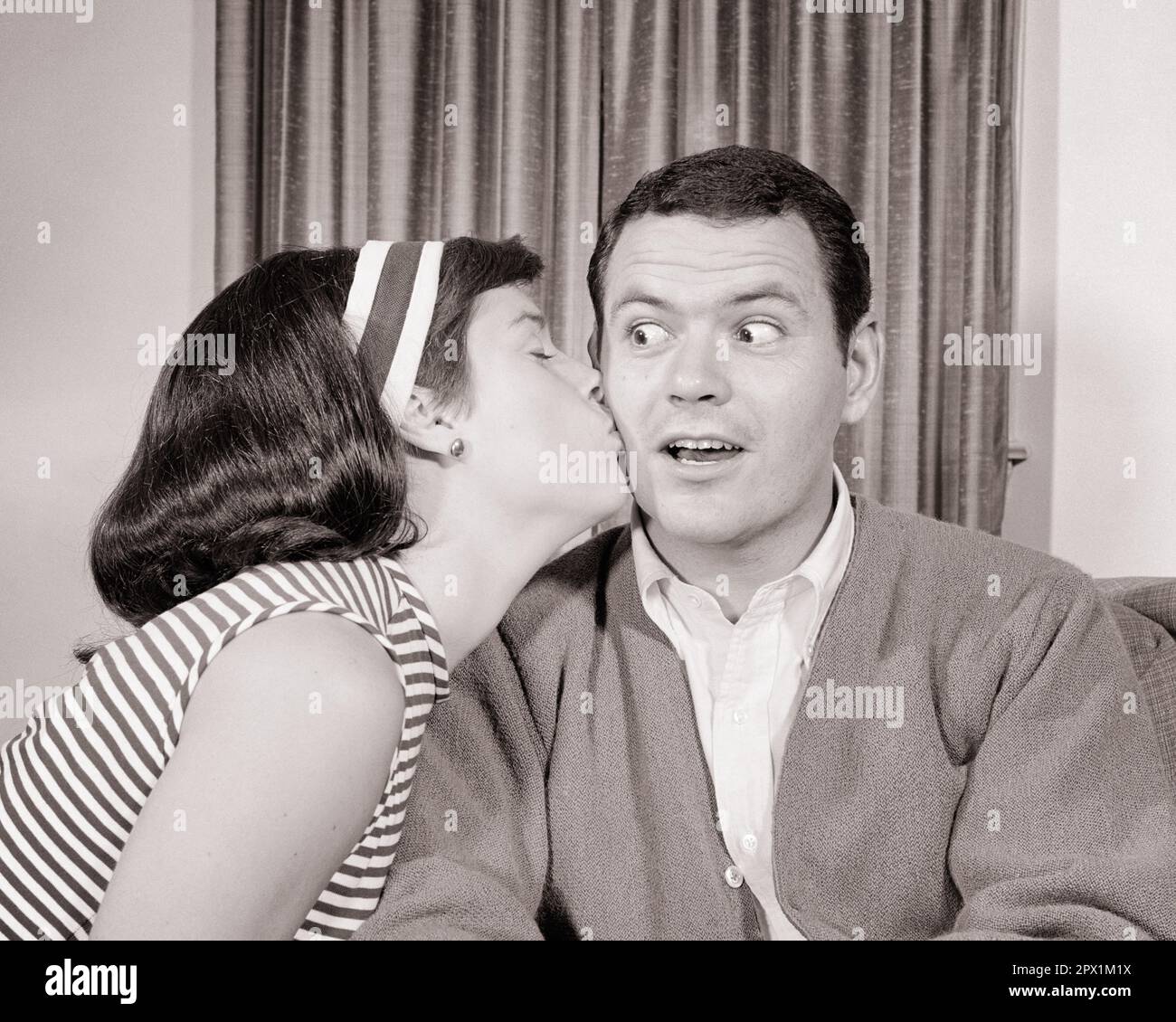 1960s woman kissing a surprised man on the cheek r21142 har001 hars