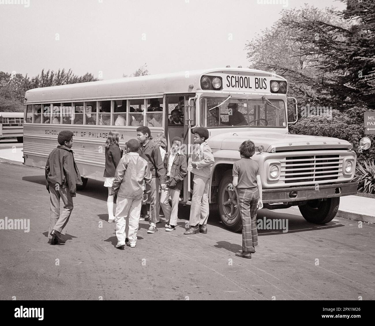 1970s DIVERSE GROUP OF HIGH SCHOOL STUDENTS GETTING ON SCHOOL BUS - s18721 HAR001 HARS COPY SPACE FRIENDSHIP FULL-LENGTH MALES TEENAGE GIRL TEENAGE BOY B&W SADNESS SCHOOLS 8 HAPPINESS ADVENTURE DISCOVERY AFRICAN-AMERICANS AFRICAN-AMERICAN EXCITEMENT KNOWLEDGE BLACK ETHNICITY PRIDE OPPORTUNITY HIGH SCHOOL HIGH SCHOOLS CONNECTION VARIOUS VARIED COOPERATION EIGHT GROWTH JUVENILES BLACK AND WHITE CAUCASIAN ETHNICITY HAR001 OLD FASHIONED AFRICAN AMERICANS Stock Photo