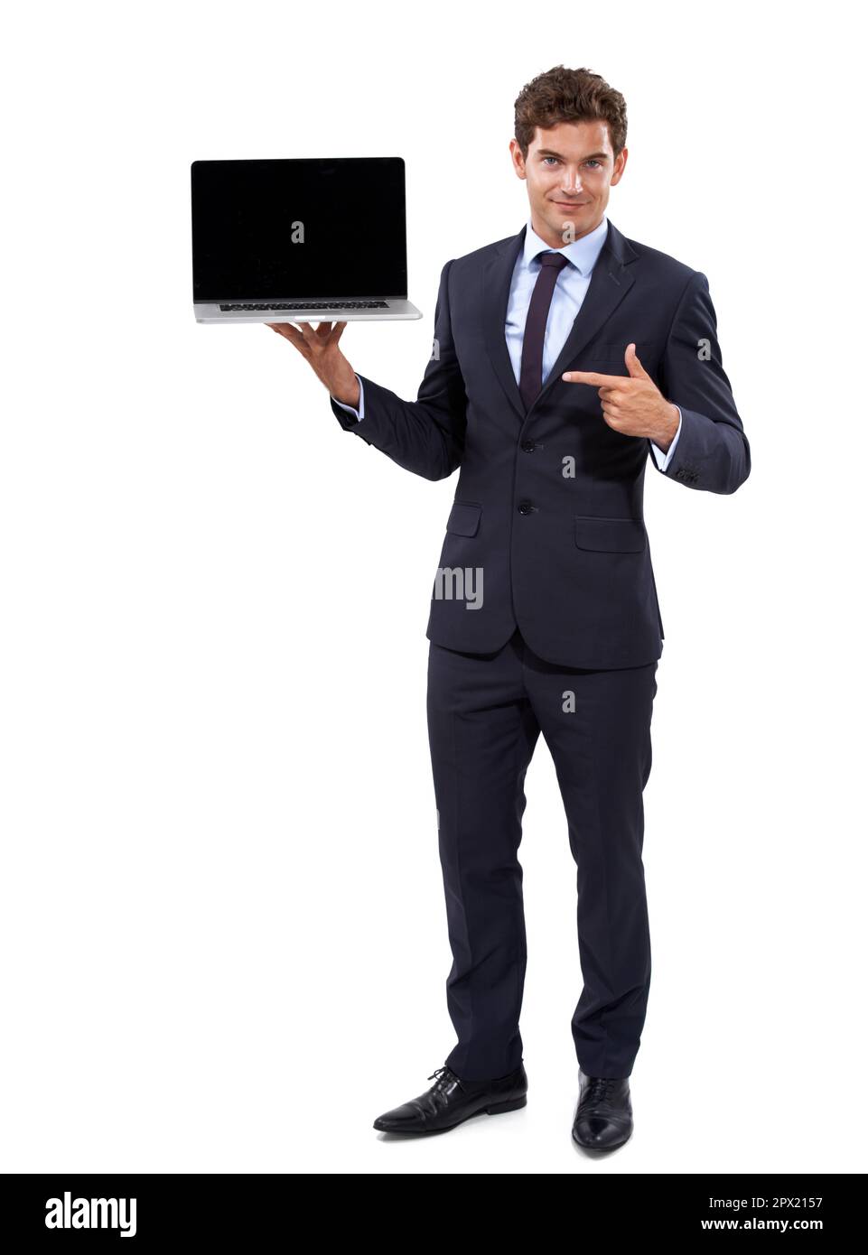 Put your advertisement on my screen. A handsome young businessman displaying a laptop against white background. Stock Photo