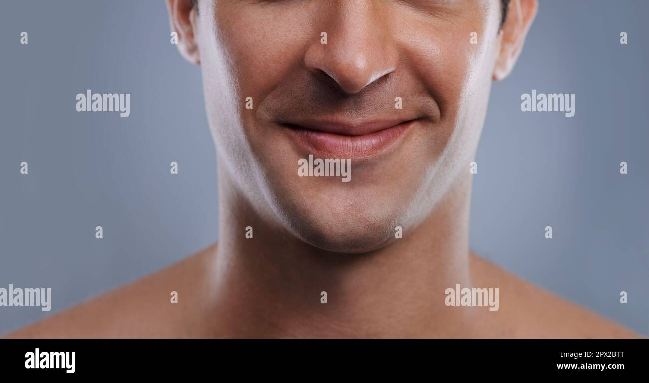 Kissable lips. Cropped image of a handsome mans mouth smiling. Stock Photo