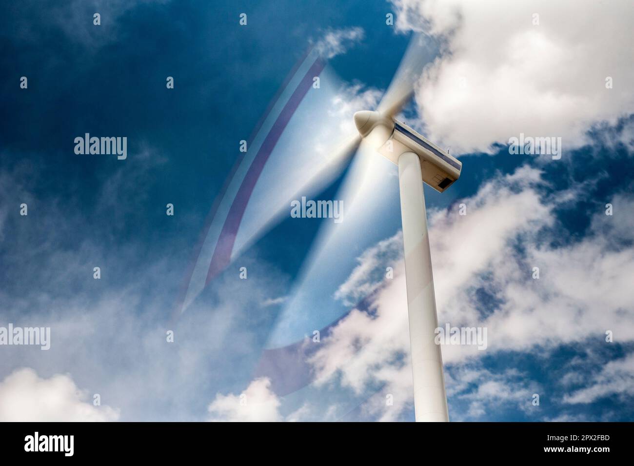 The rotor blades of a wind turbine, blurred by the rotation, in the