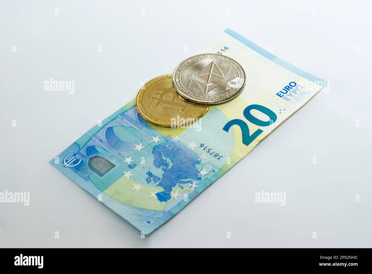 Physical Bitcoin and Ethereum coin over a twenty euro bill over white  background. Cryptocurrency exchange, investment concept Stock Photo - Alamy