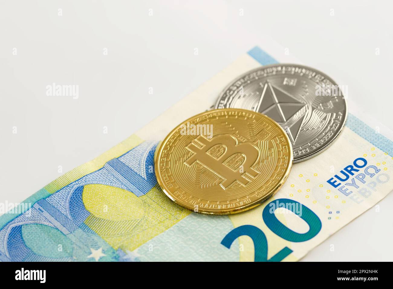 Physical Bitcoin and Ethereum coin over a twenty euro bill over white  background. Cryptocurrency exchange, investment concept Stock Photo - Alamy