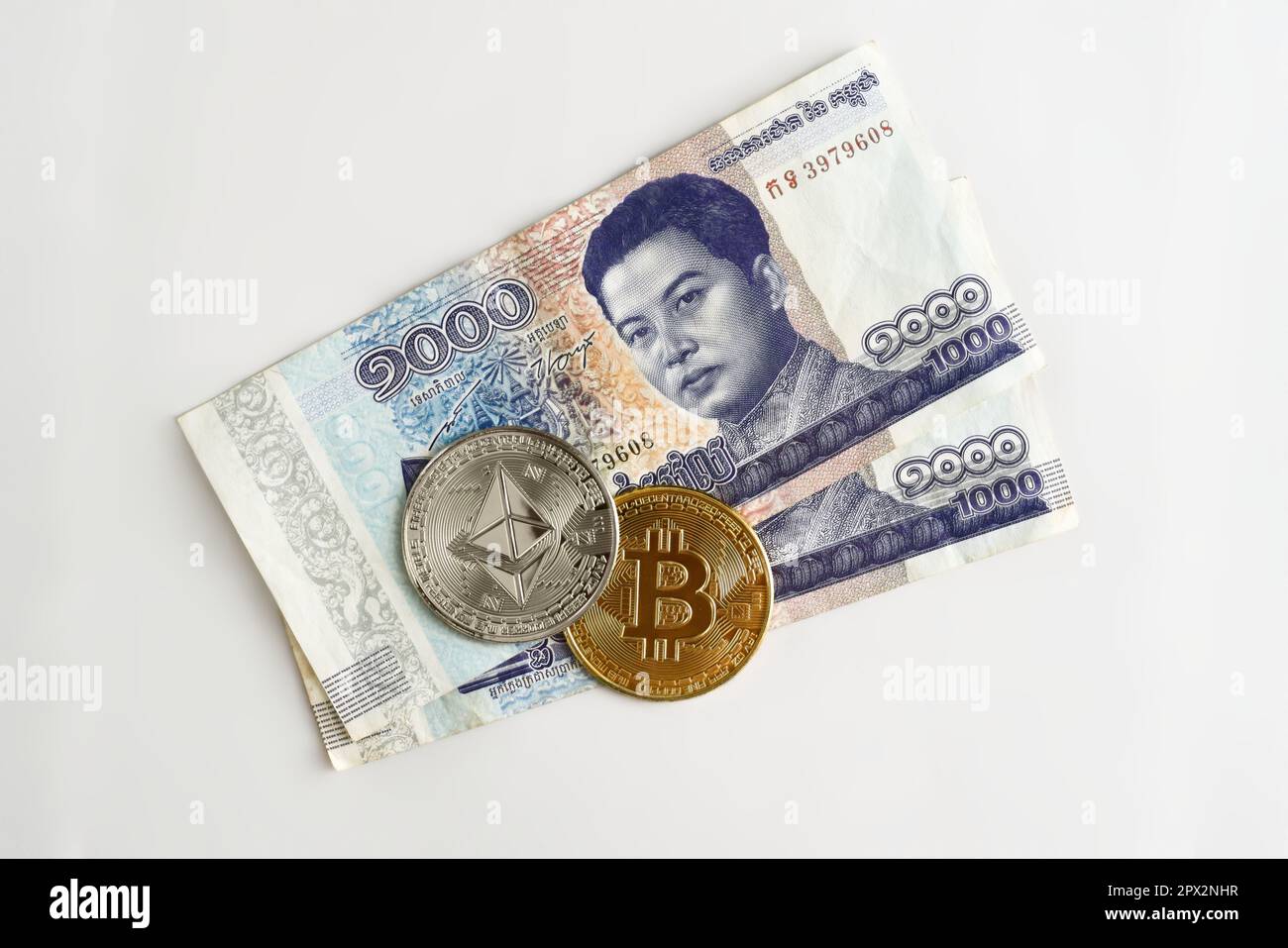 Physical Ethereum and Bitcoin over a thousand cambodian riel bill.  Cryptocurrency exchange, investment concept Stock Photo - Alamy