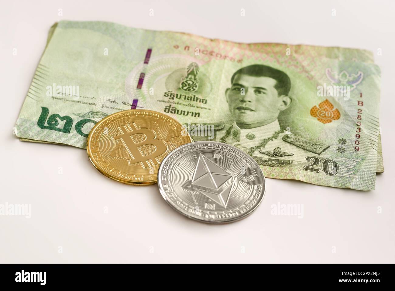 Physical Ethereum and Bitcoin over a twenty Thai Baht bill. Cryptocurrency  exchange, investment concept Stock Photo - Alamy