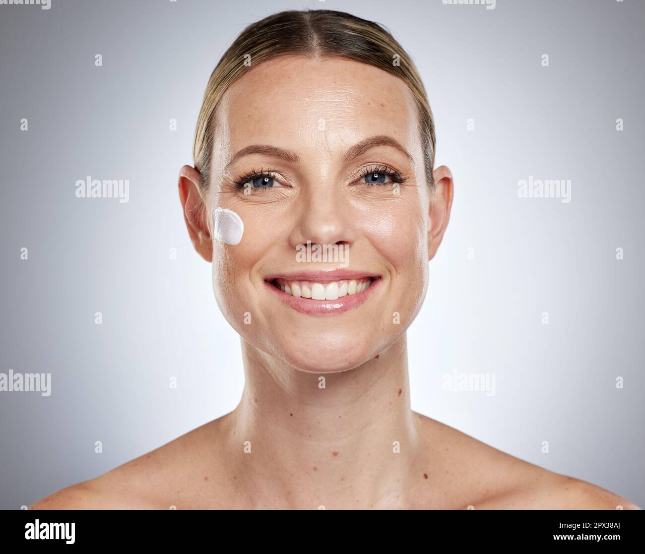 Skincare, facial and portrait of woman with cream, lotion and skincare products on gray