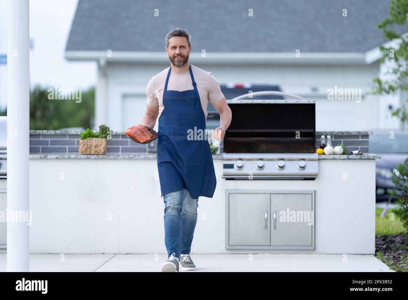 Cook Walk image of man cook seafood barbecue walk with fish. man cook seafood ...