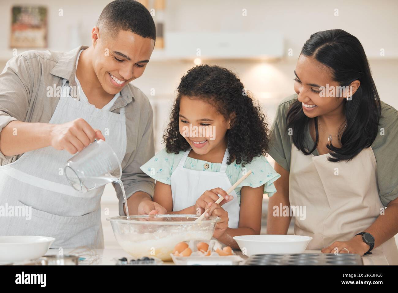 Make the batter runny but not too lose. a father pouring water into a
