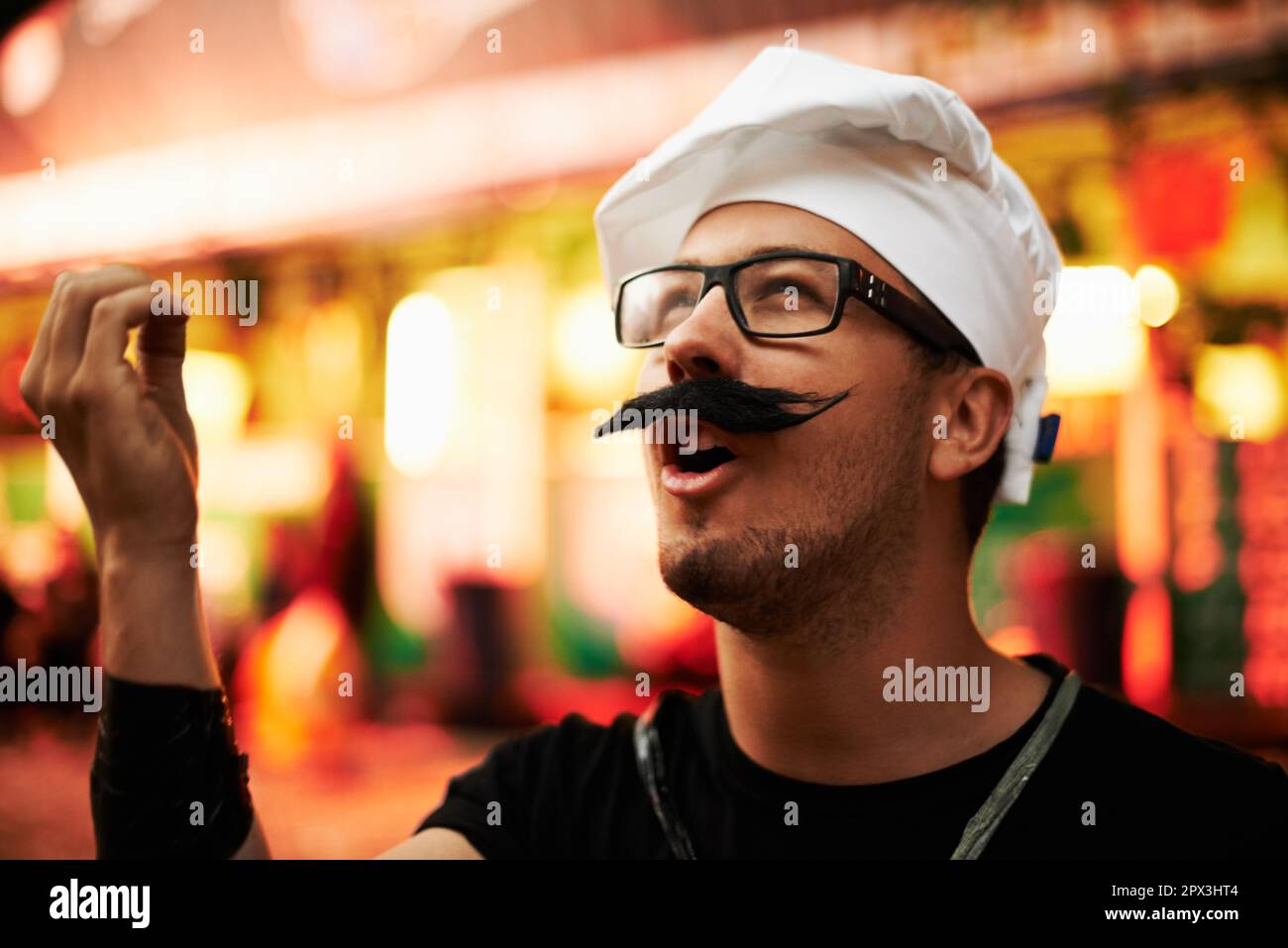 Its manifique. a young man dressed up as a chef at an outdoor festival  Stock Photo - Alamy
