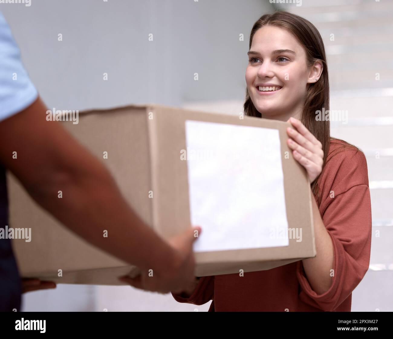 Sometimes joy comes in a box. a woman accepting her delivery from the