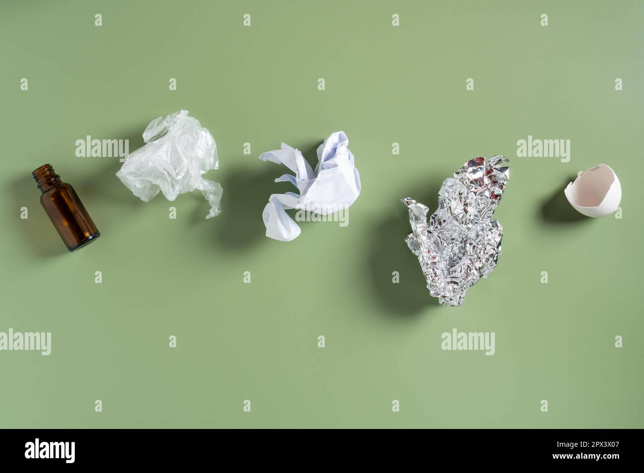 Glass bottle, plastic bag, crumpled paper, organic eggshell, foil on
