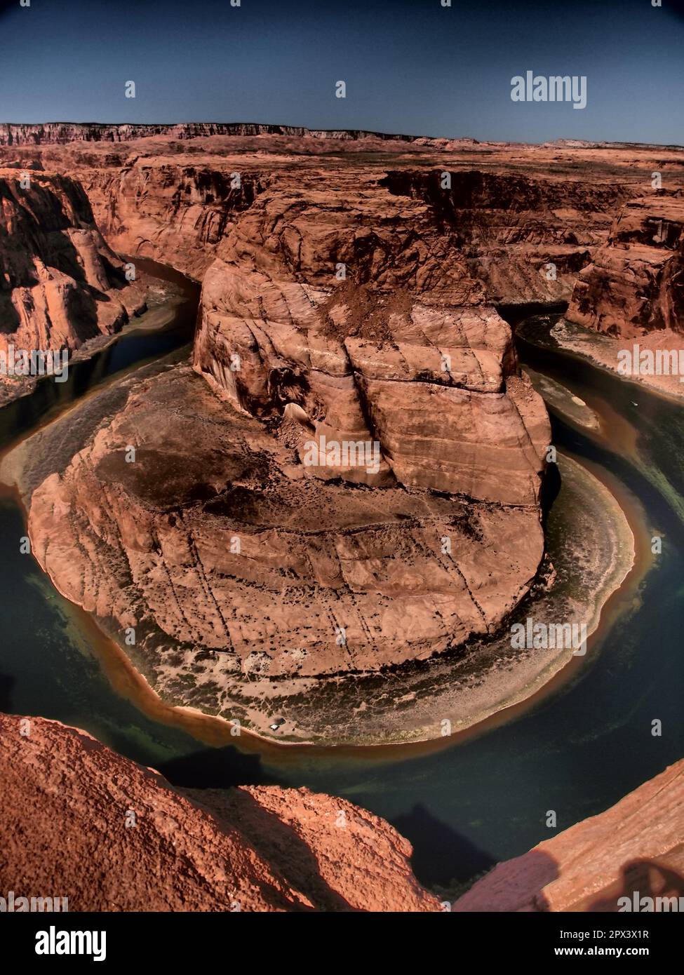 Horseshoe Bend and the Colorado River near Page Arizona. Over 1000 feet to the river bottom below is a camp site and boat excusions Stock Photo