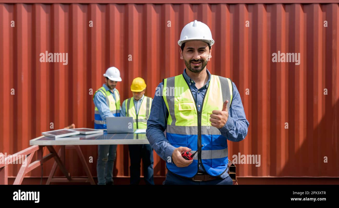 Project manager raise finger thumb up with a smile while holding walkie ...