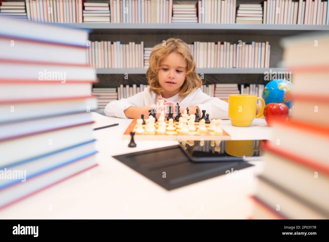 Young white child playing a game of chess on large chess board. Chess board  on table in front of school boy thinking of next move by Len44ik Vectors &  Illustrations with Unlimited