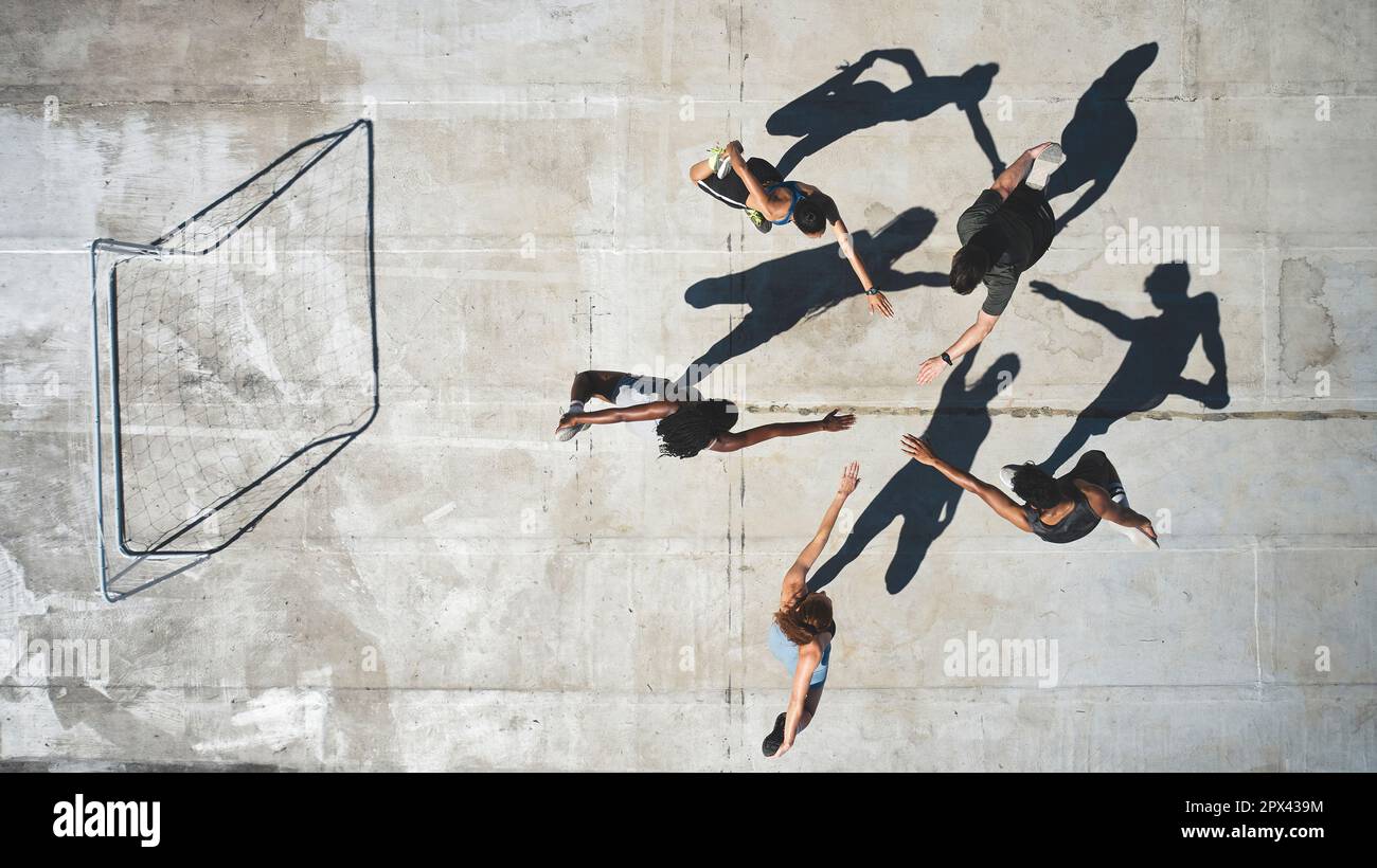 Top view, soccer team and stretching for fitness, workout or game training on Portugal city building rooftop. Sports men, women and football player pe Stock Photo